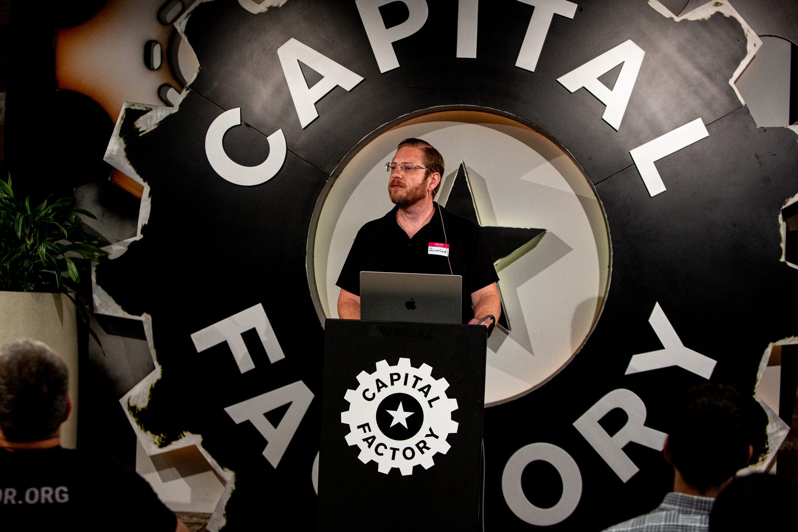 Jonathan Malkin at the podium at Capital Factory in Austin, speaking to a seated audience.